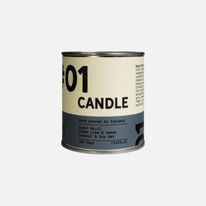 A paint pot style candle tin measuring 7.5cm x 7.5cm, with a lever lid on top and a wrap around paper label containing graphics that say 01 Candle, hand poured in Ireland, fresh lime & amber.