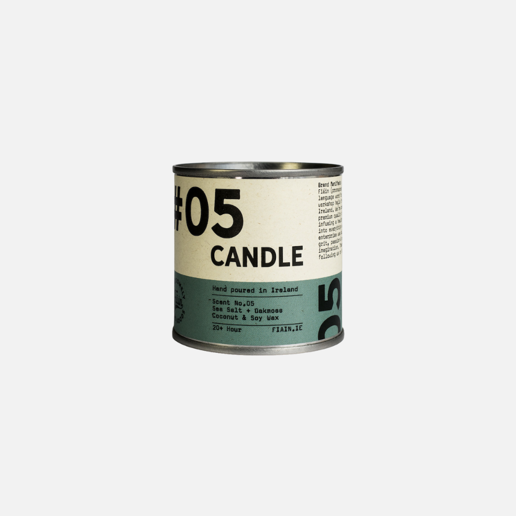 A paint pot style candle tin measuring 5.5cm x 5.5cm, with a lever lid on top and a wrap around paper label containing graphics that say 01 Candle, hand poured in Ireland, sea salt & oakmoss.