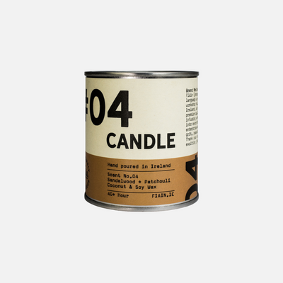 A paint pot style candle tin measuring 7.5cm x 7.5cm, with a lever lid on top and a wrap around paper label containing graphics that say 01 Candle, hand poured in Ireland, sandalwood & patchouli.